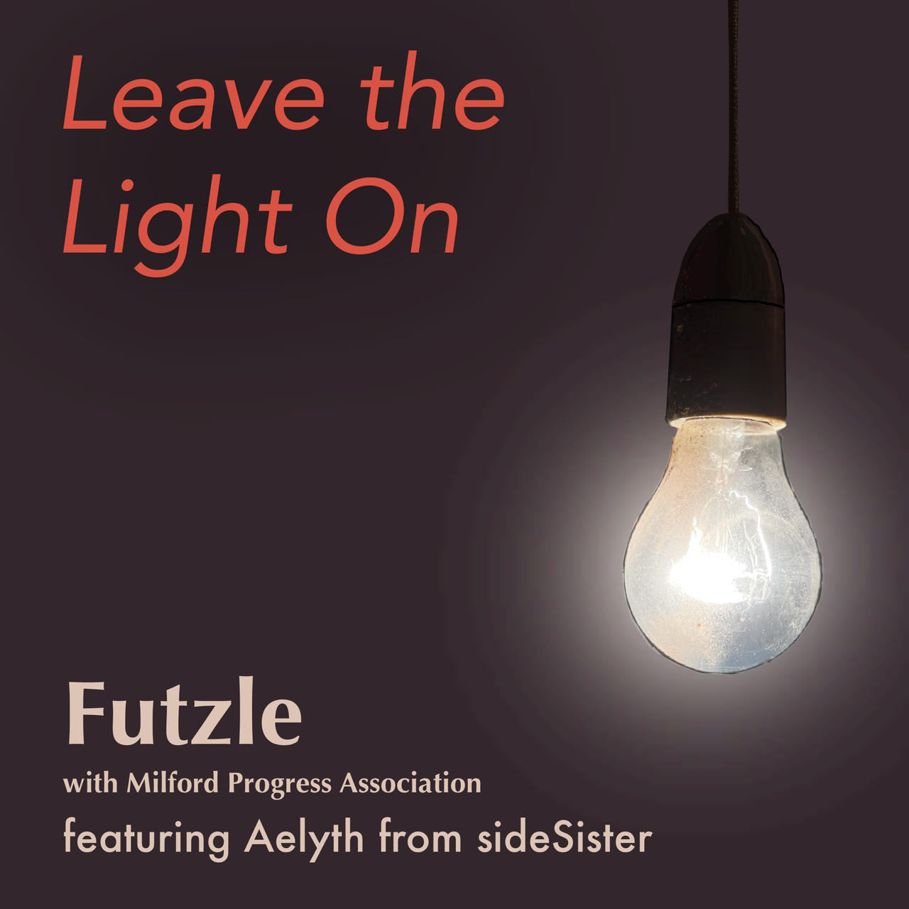 An incandescent light bulb hangs from a woven cord. It is turned on and casts a bloom of light against a dark background.
