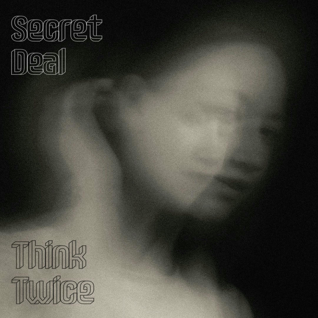 A monochrome image of a face, blurred and double-imaged.